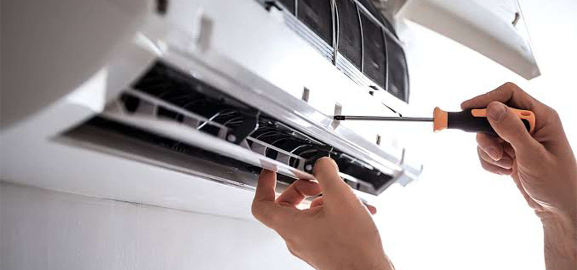 Air conditioner service technician at work